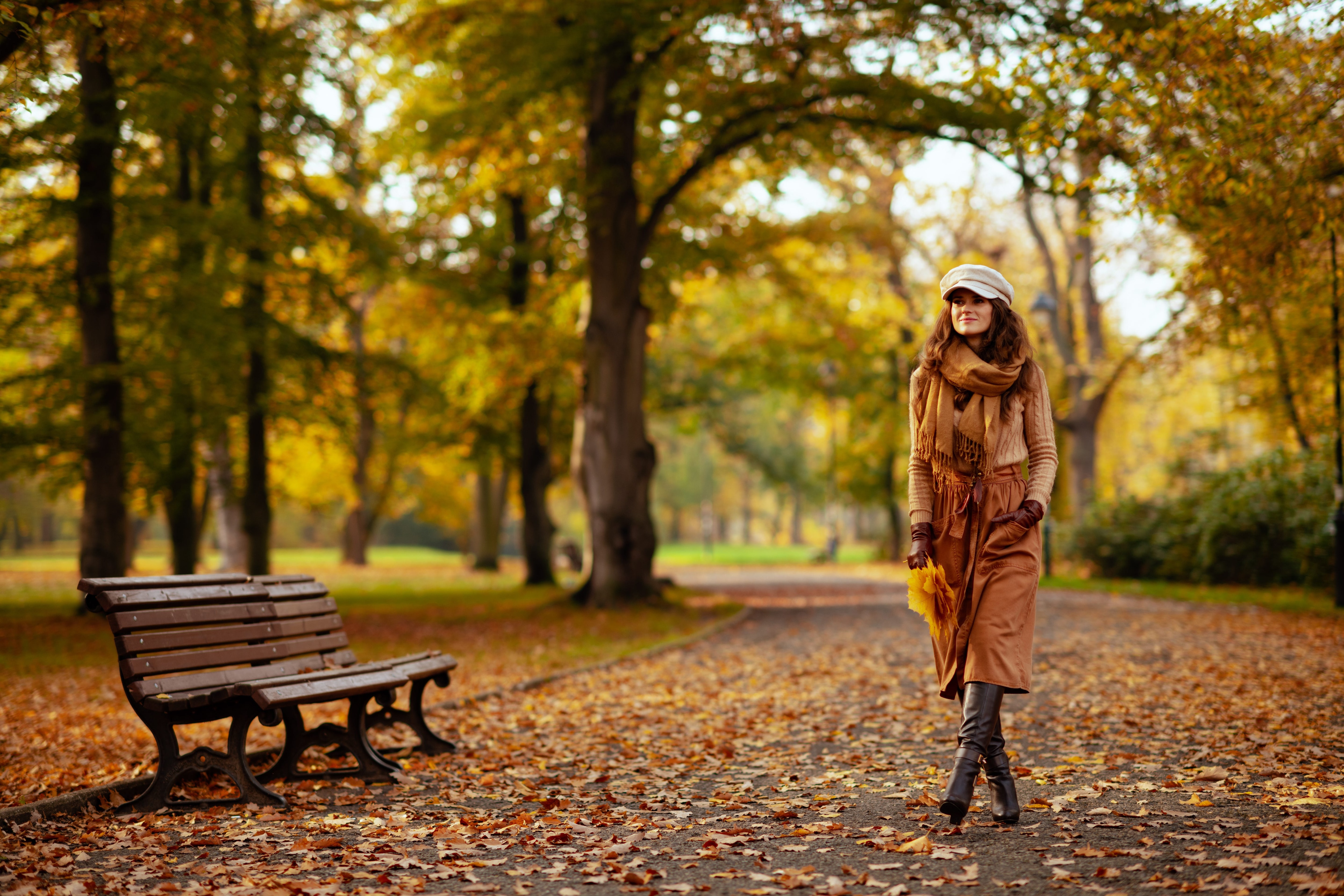 Woman walking through a park during autumn.